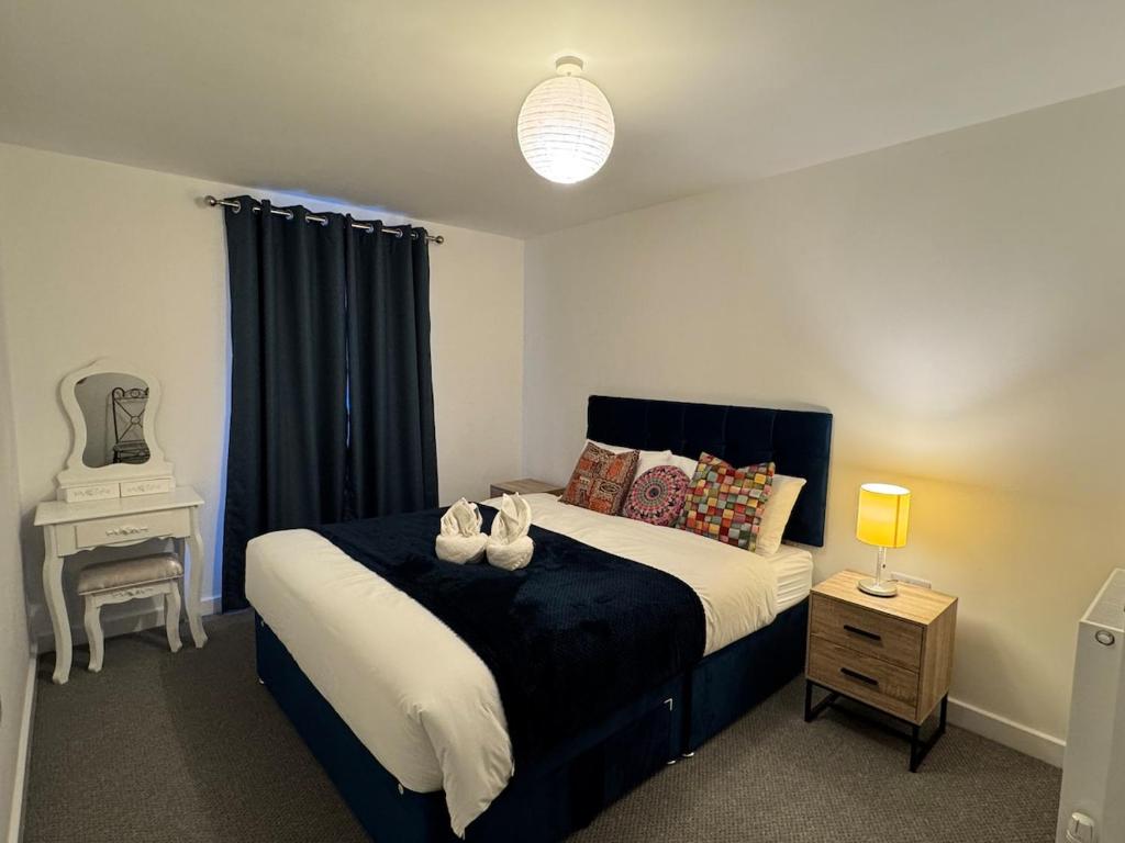 a bedroom with a bed with two shoes on it at town centre 3, 1st floor, king bed entire flat in Huntingdon