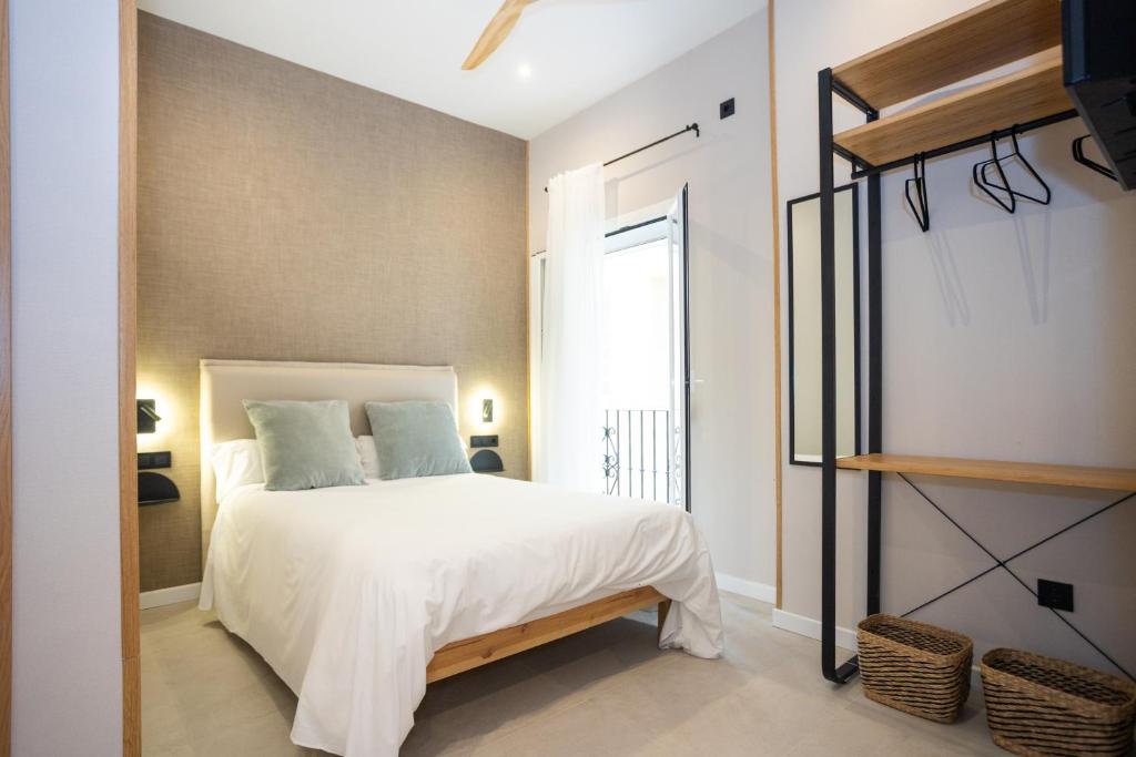 Posteľ alebo postele v izbe v ubytovaní Chinitas Urban Rooms