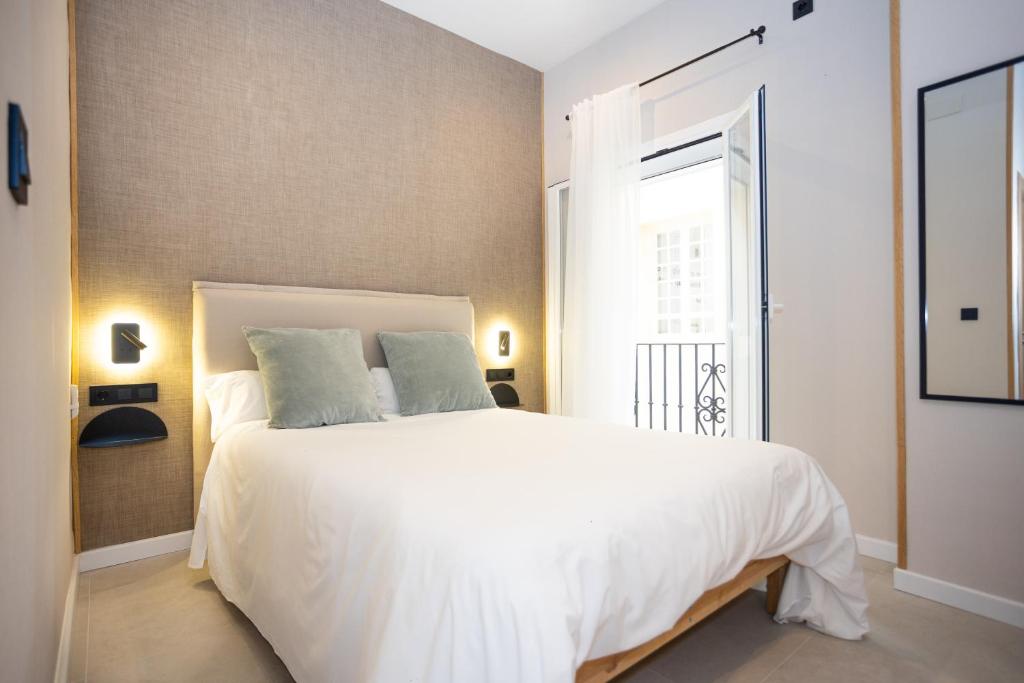 Posteľ alebo postele v izbe v ubytovaní Chinitas Urban Rooms
