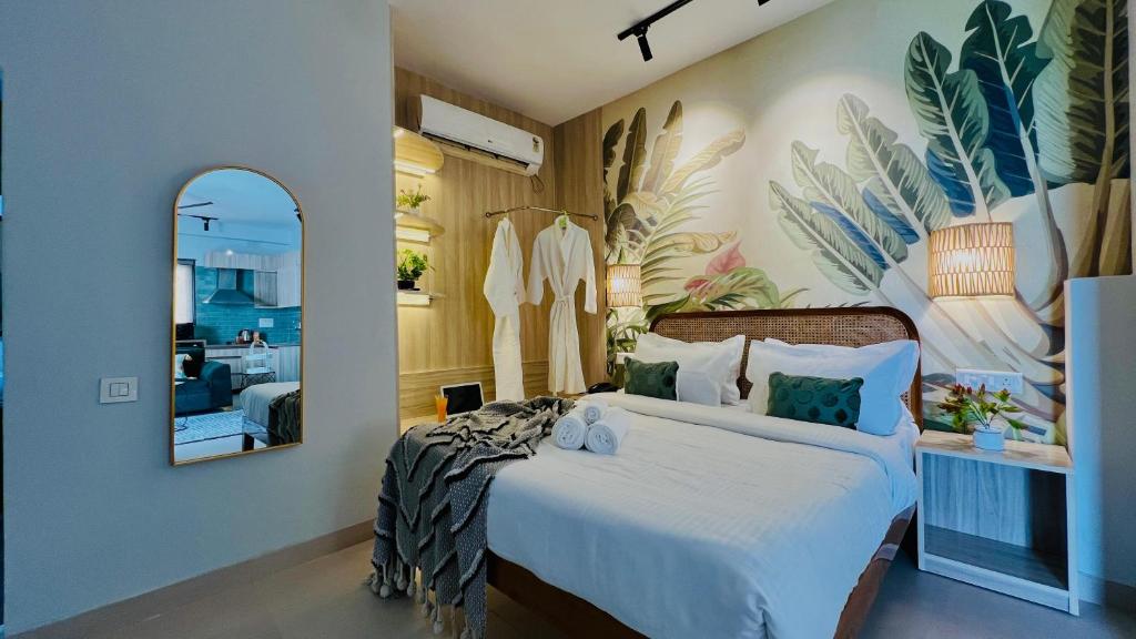 a bedroom with a large bed and a mirror at BluO Penthouse #staycation Bathtub, Terrace Garden in Gurgaon