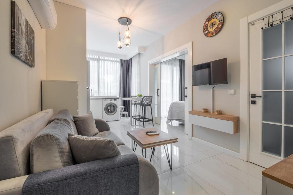 a living room with a couch and a table at Camelia 9 in Alanya