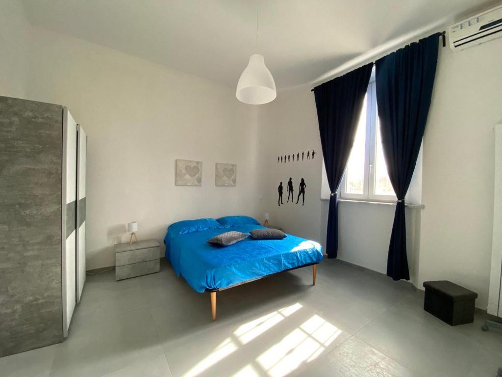 Postel nebo postele na pokoji v ubytování HERA'S HOME Pisa