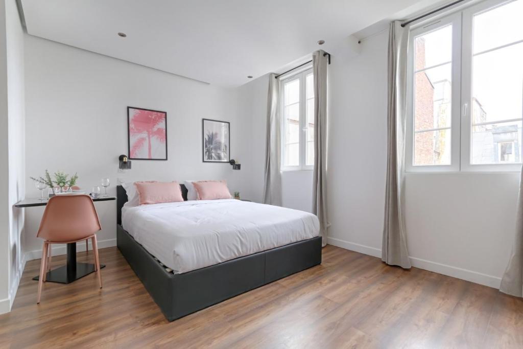 une chambre blanche avec un lit et un bureau dans l'établissement TBS 314 - Bright studio near Marais district, à Paris