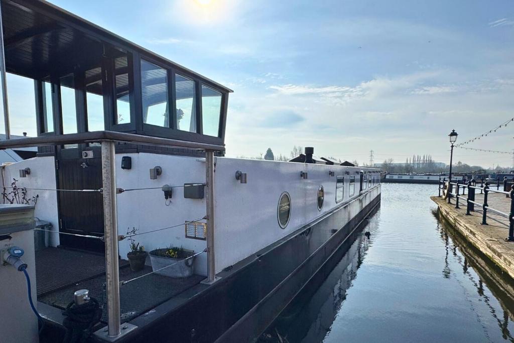 a boat is docked at a dock in the water at The Swan Flotel - Barton Marina in Burton upon Trent