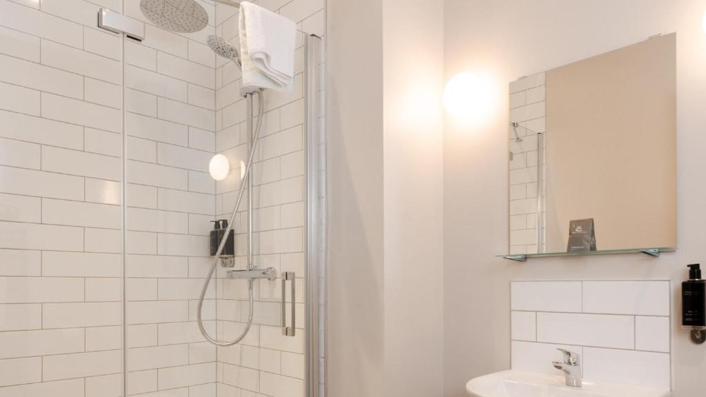 a bathroom with a shower and a sink at Marine Hotel Ballycastle in Ballycastle