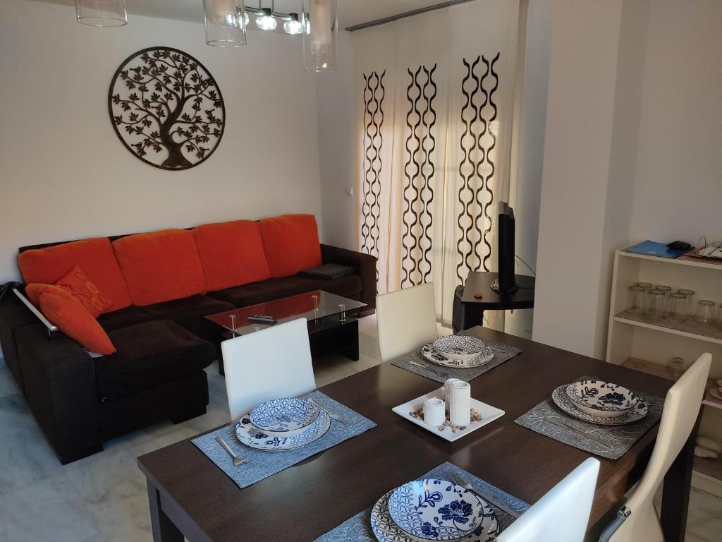 a living room with a table and a couch at Apartamento torrox in Torrox Costa