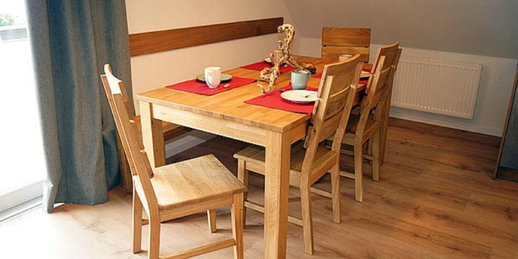 a wooden dining room table with chairs and a table at Winzerhof Weber in Buggingen