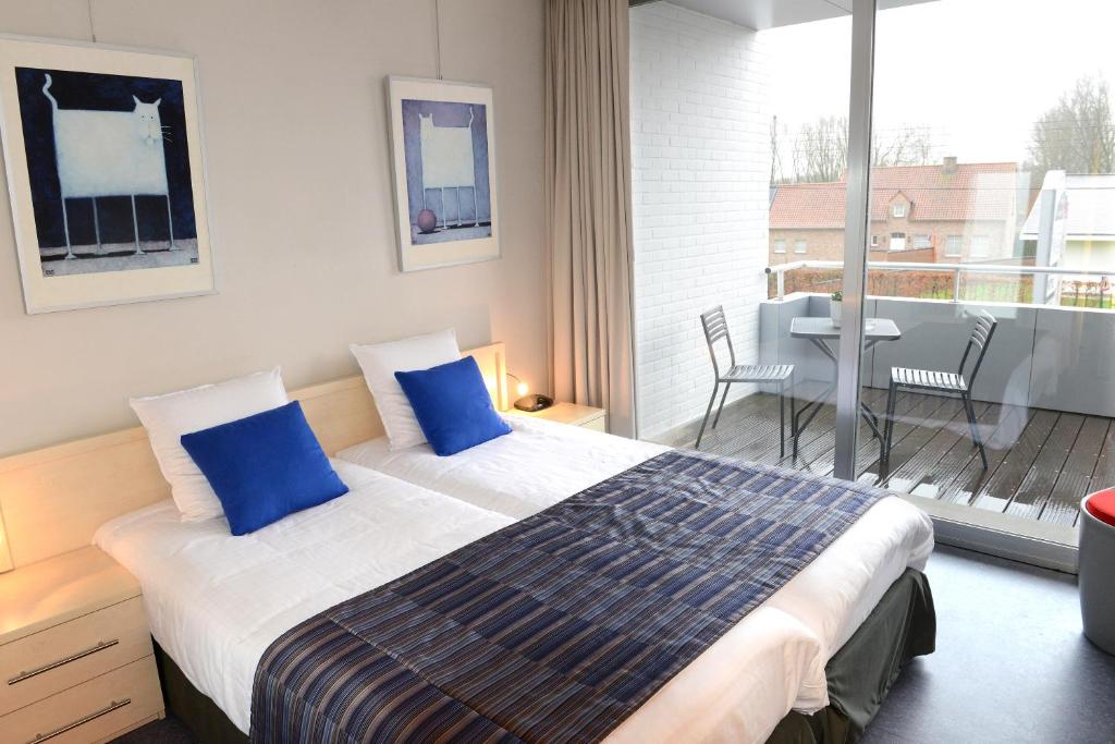 Postel nebo postele na pokoji v ubytování Hotel Vijfwegen