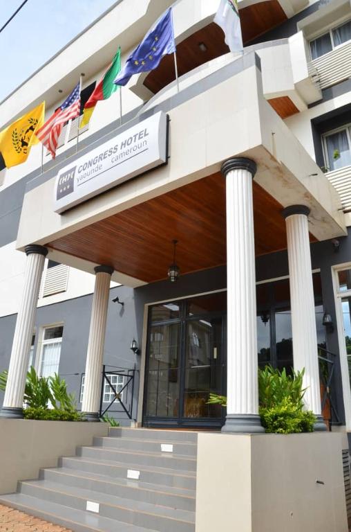 a building with flags on the front of it at CONGRESS HOTEL Yaoundé in Yaoundé