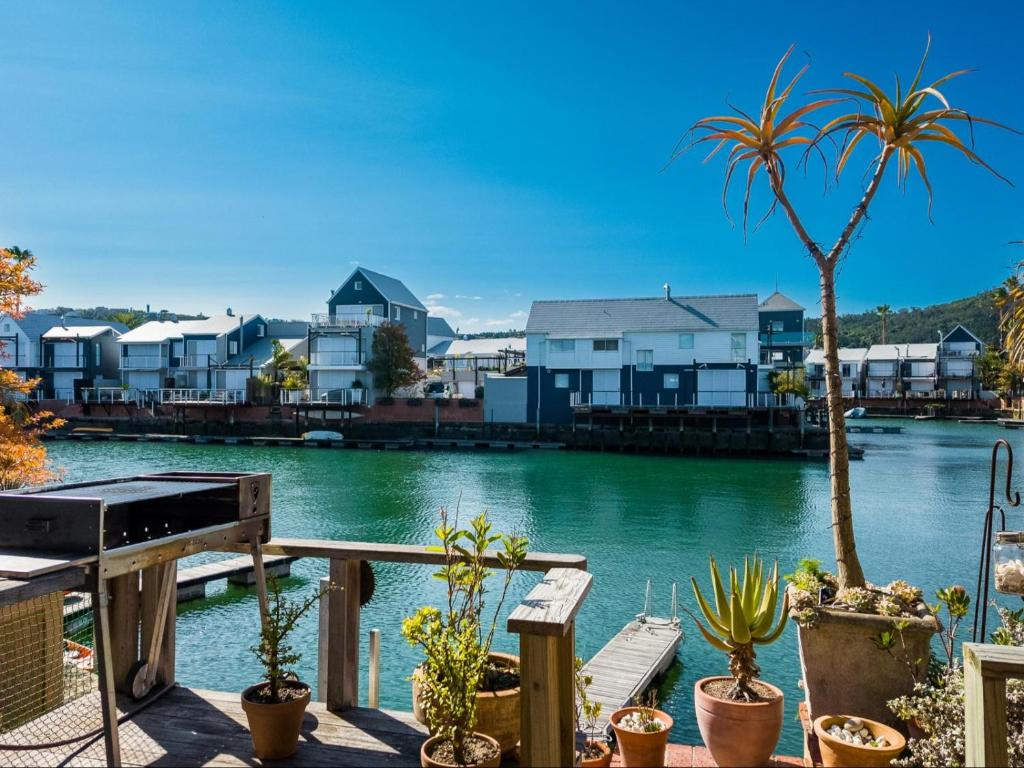 a view of a river with houses and plants at Knysna Quays Waterfront Accomodation in Knysna