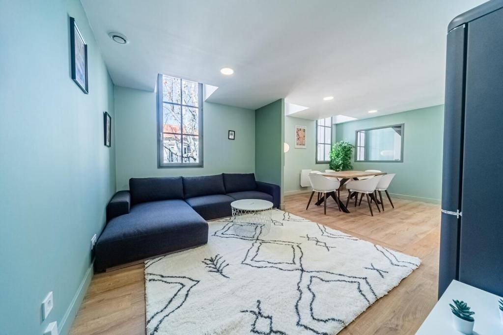 un salon avec un canapé bleu et une table dans l'établissement T4 d'exception à Aix, à Aix-en-Provence