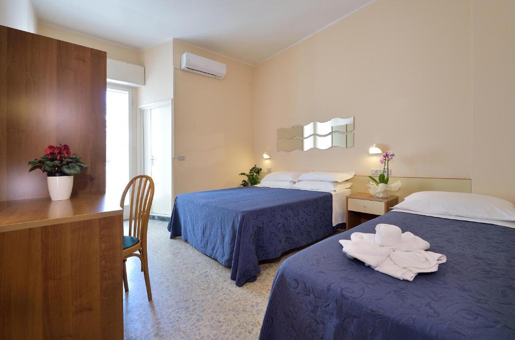 Postel nebo postele na pokoji v ubytování Hotel Oltremar B&B