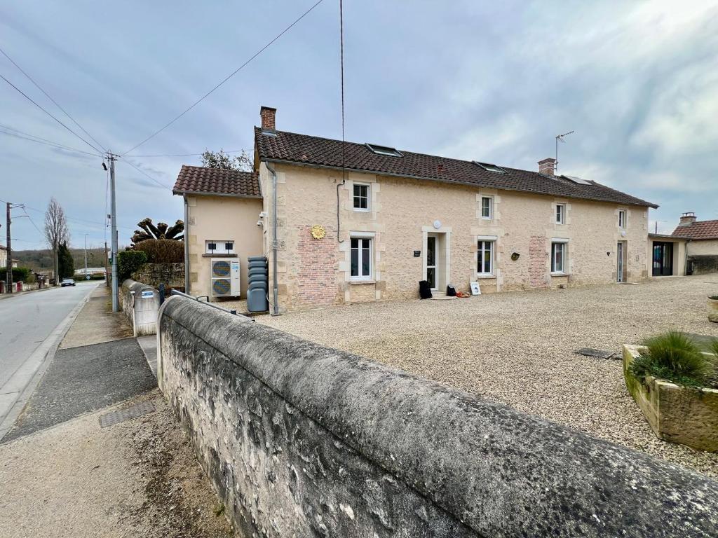 a stone wall in front of a house at Chez Marcel - Maison 3 chambres in Lussac-les-Châteaux