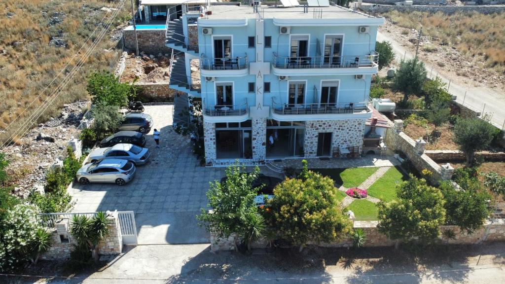 an aerial view of a house with cars parked in a parking lot at Vila Llaka in Himare