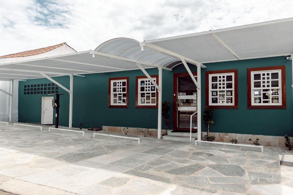 a blue building with a white roof at Pousada Tajupá in Pirenópolis