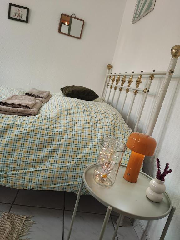 une chambre avec un lit et une table avec une lampe dans l'établissement La casa verde, à Pouilly-en-Auxois