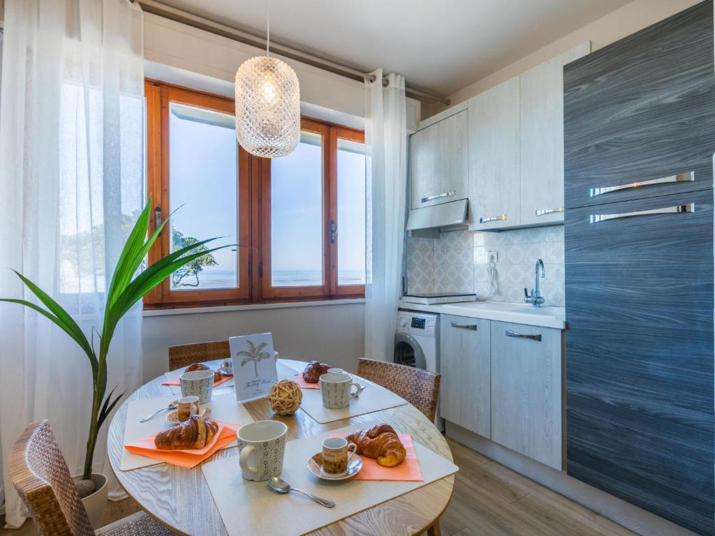 a kitchen with a table with food on it at Apartment Mediterraneo by Interhome in San Vincenzo