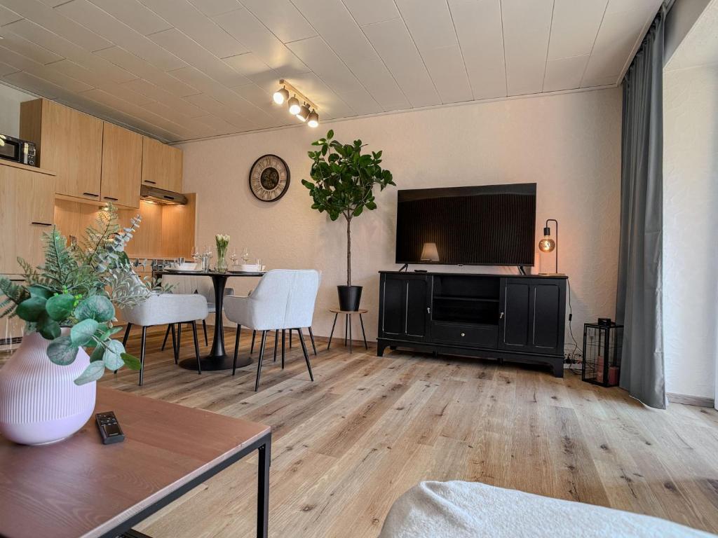 a living room with a large flat screen tv at FeWo Nordstern - Schillig in Wangerland