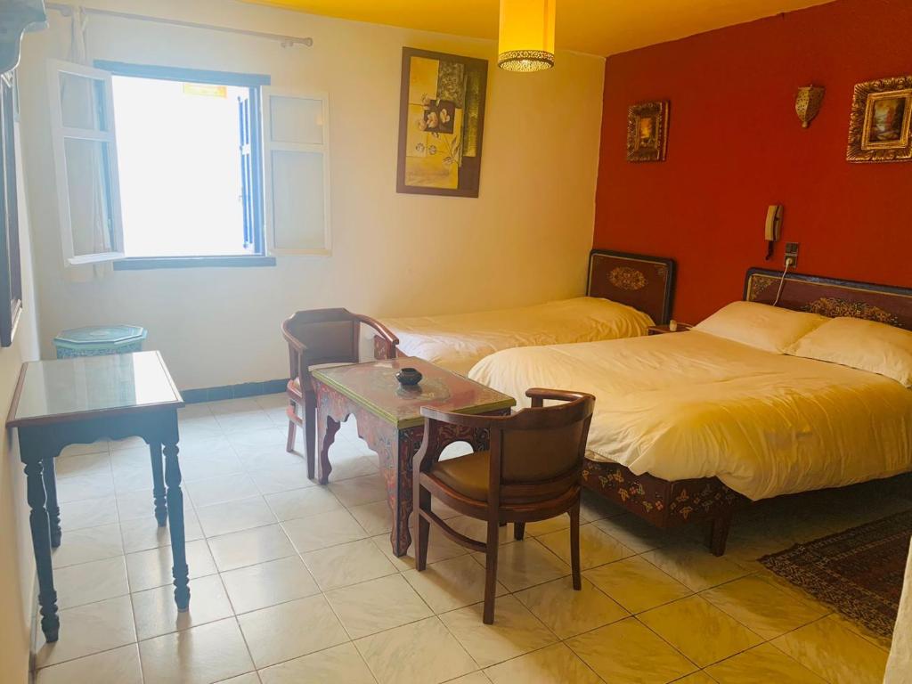 Postel nebo postele na pokoji v ubytování Hotel Sahara