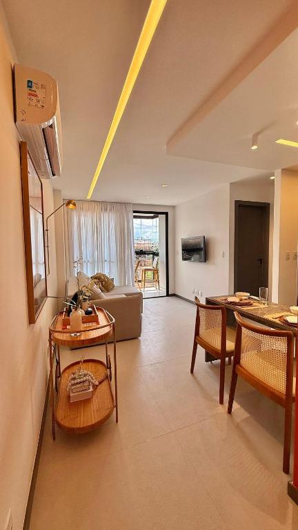 a living room with a couch and a table at Apartment JC 903: Jardim Camburi. Vitória- E.S. in Carapina
