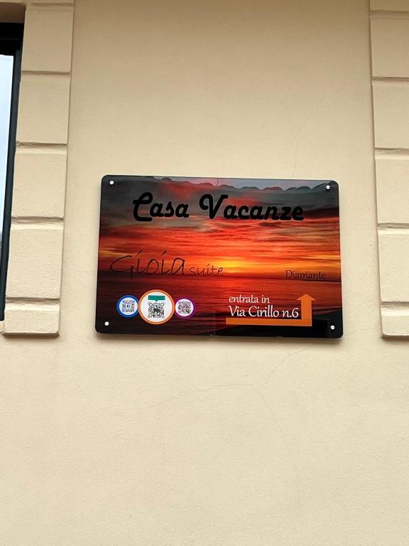 a sign on a wall with a sunset at GIOIA suite Casa Vacanze Diamante in Diamante