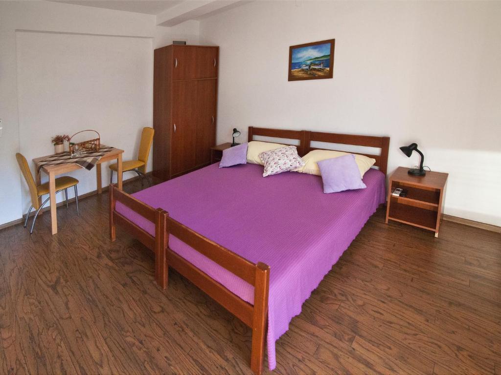 a bedroom with a large bed and a table at Villa Era in Dubrovnik