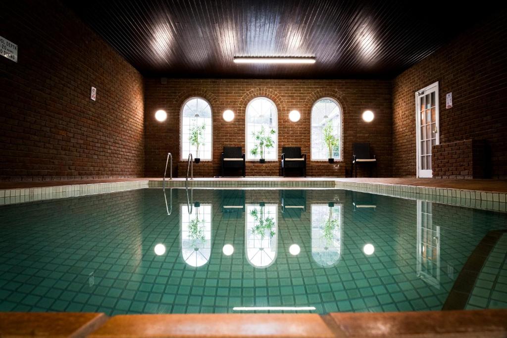 a swimming pool in a brick building with a swimming pool at The Brunswick in Shanklin