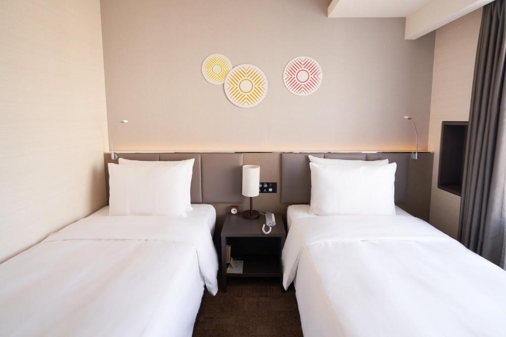 Postel nebo postele na pokoji v ubytování Holiday Inn & Suites Shin Osaka by IHG