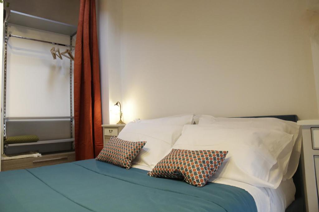 a bedroom with a bed with two pillows on it at Midnight blues for 3 people near the airport in Azzano San Paolo