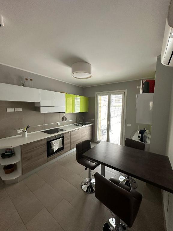 a kitchen with a table and chairs in it at Casa vacanza relax in Ortona