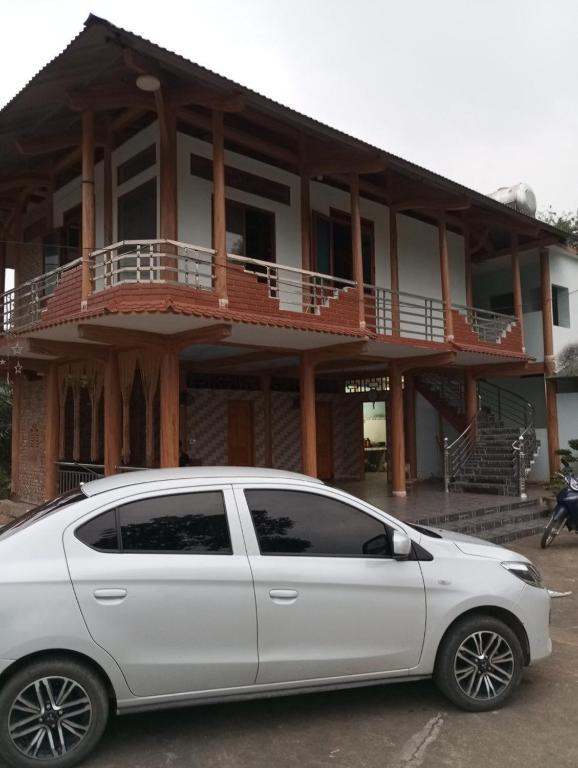 a white car parked in front of a building at Trần Sơn Homestay in Tuyên Quang