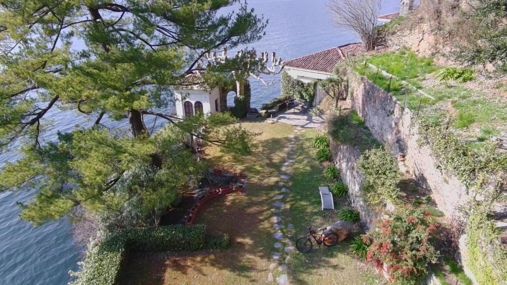 an aerial view of a house next to the water at On Lake Villa Cicci e Sandro in Bellano