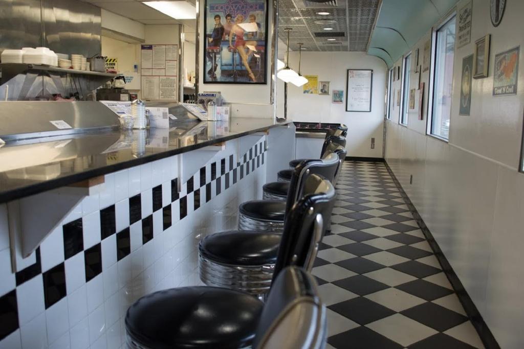 a line of stools in a fast food restaurant at Travelodge by Wyndham Yampa in Yampa