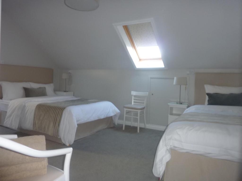 Postel nebo postele na pokoji v ubytování Westwinds Guestlodge