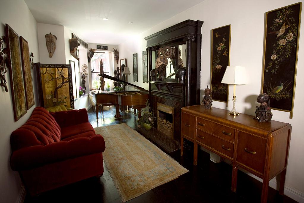 a living room with a couch and a dresser at The Gallery House in New York