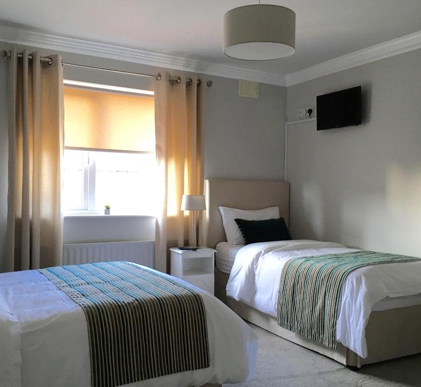 Ένα ή περισσότερα κρεβάτια σε δωμάτιο στο Westwinds Guestlodge