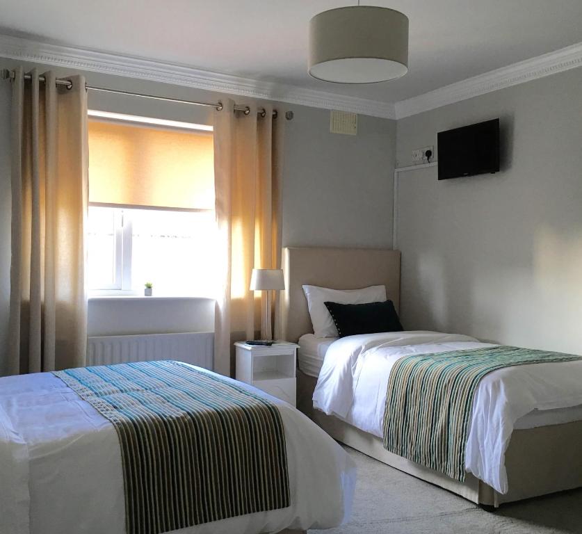 Postel nebo postele na pokoji v ubytování Westwinds Guestlodge