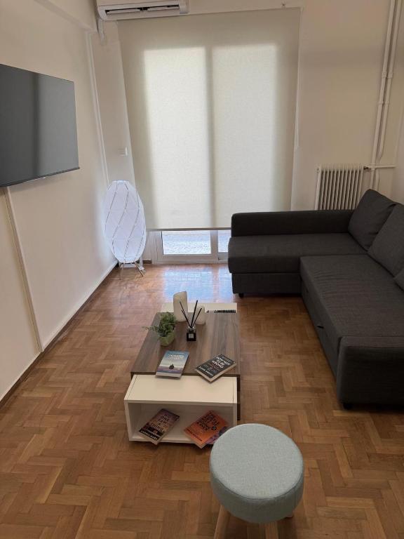 a living room with a couch and a coffee table at Hidden Gem Apartment in Patra