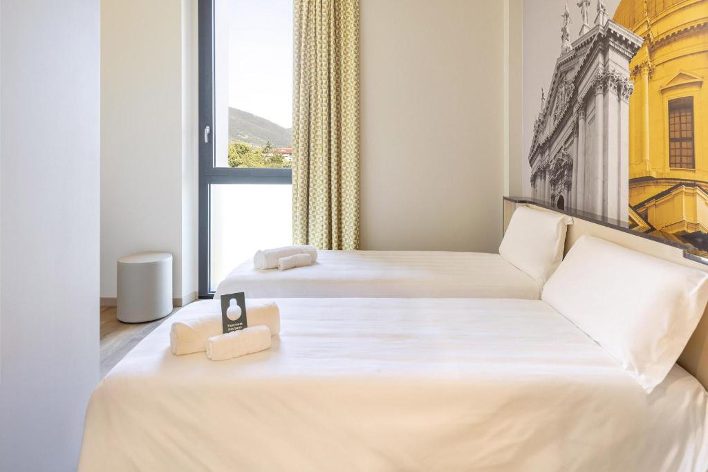 Postel nebo postele na pokoji v ubytování B&B Hotel Brescia
