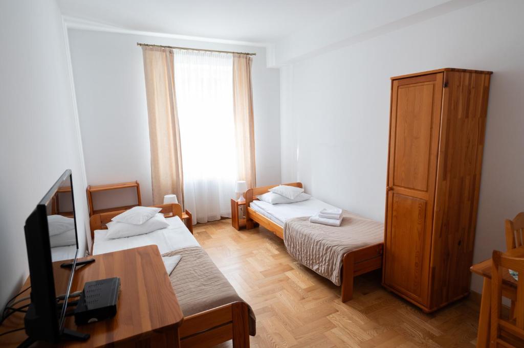Posteľ alebo postele v izbe v ubytovaní Pokoje Gościnne Dom św. Szymona