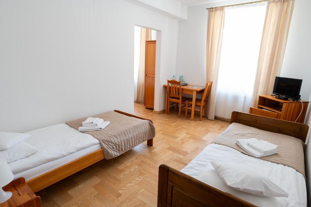 Posteľ alebo postele v izbe v ubytovaní Pokoje Gościnne Dom św. Szymona