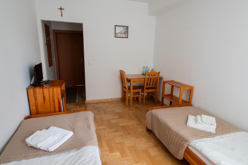 Posteľ alebo postele v izbe v ubytovaní Pokoje Gościnne Dom św. Szymona
