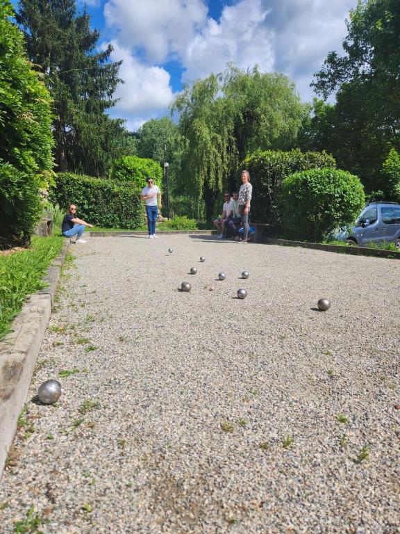 a group of people playing a game of dominoes at Camping Les Berges Du Doux in Colombier-le-Vieux