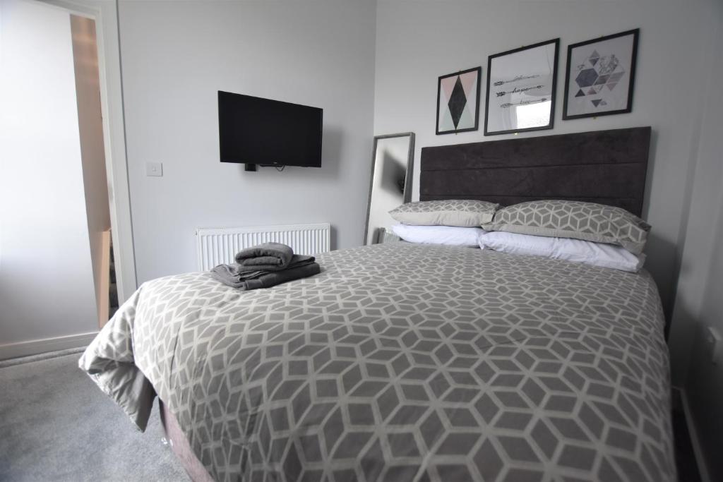 a bedroom with a large bed and a television at Central, Contractor&family Friendly, Smarttv in Sunderland