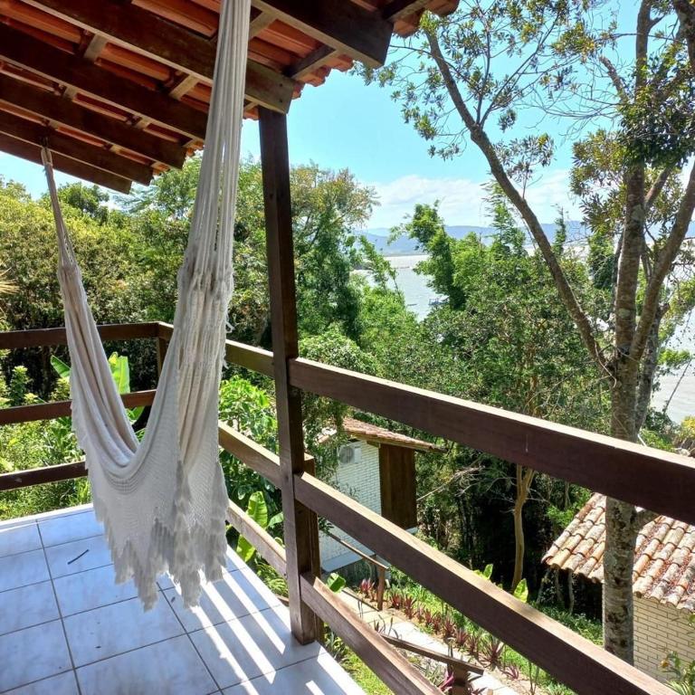 a hammock on the deck of a house at Villa in Governador Celso Ramos