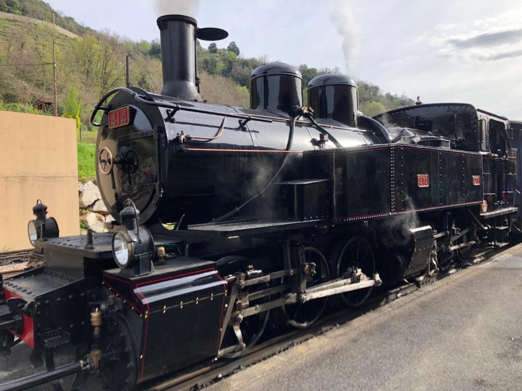 a black train is sitting on the tracks at Camping Les Berges Du Doux in Colombier-le-Vieux