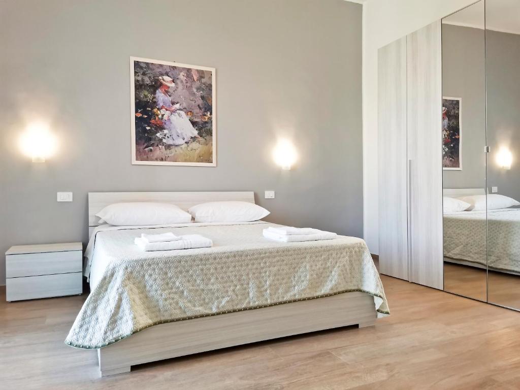 a bedroom with a large bed and a mirror at L'altro Krisà in Bari