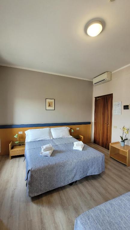 Postel nebo postele na pokoji v ubytování Hotel Montepiana