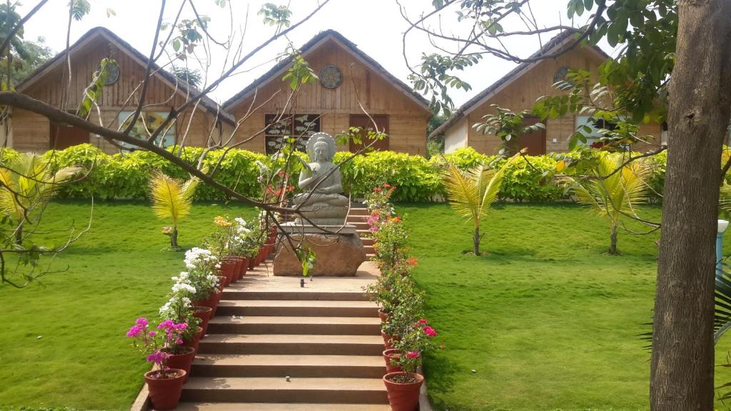 a statue in the garden of a house at Mrugavani Resort & Spa in Hyderabad