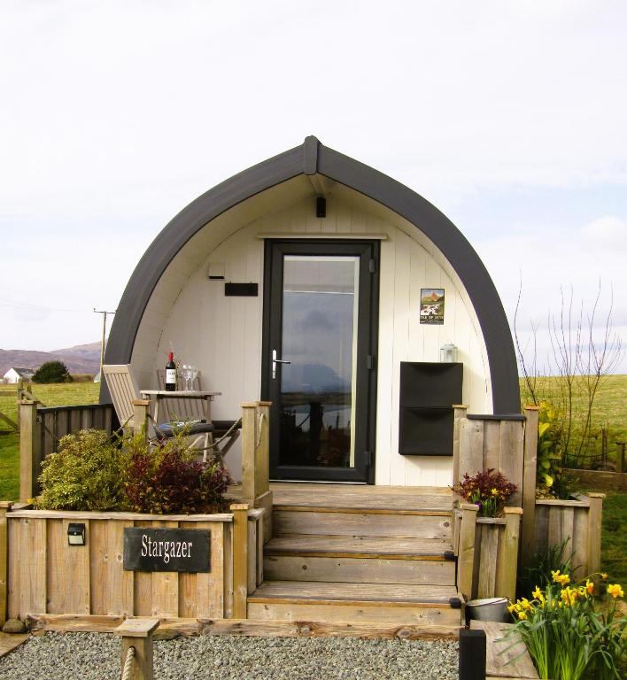a small house with a large arched doorway at Harlosh Hideaways - Stargazer Pod in Harlosh
